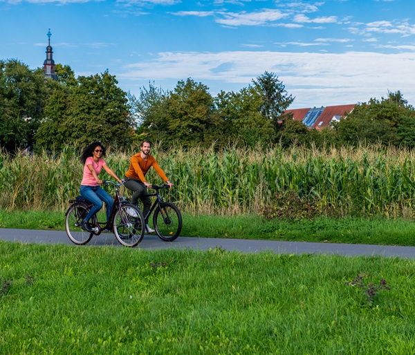 Two people cycling in fields