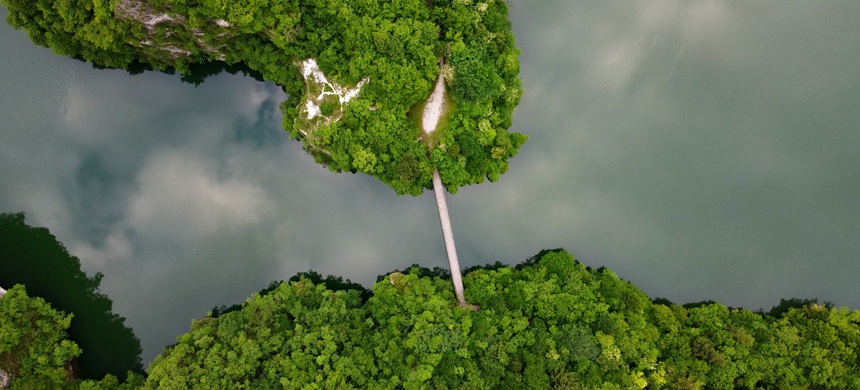 Two small green islands are connected with a small bridge
