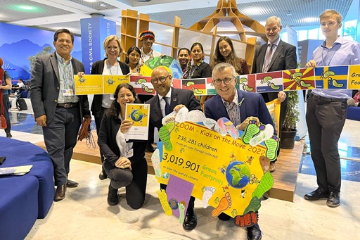 Group of people posing for the photo holding posters and signs
