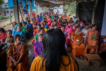 Woman standing in front of class of indigenous women and children